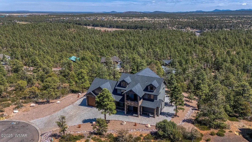 Aerial view of The Lazy Bear Way luxury vacation rental in Show Low, AZ surrounded by pine trees