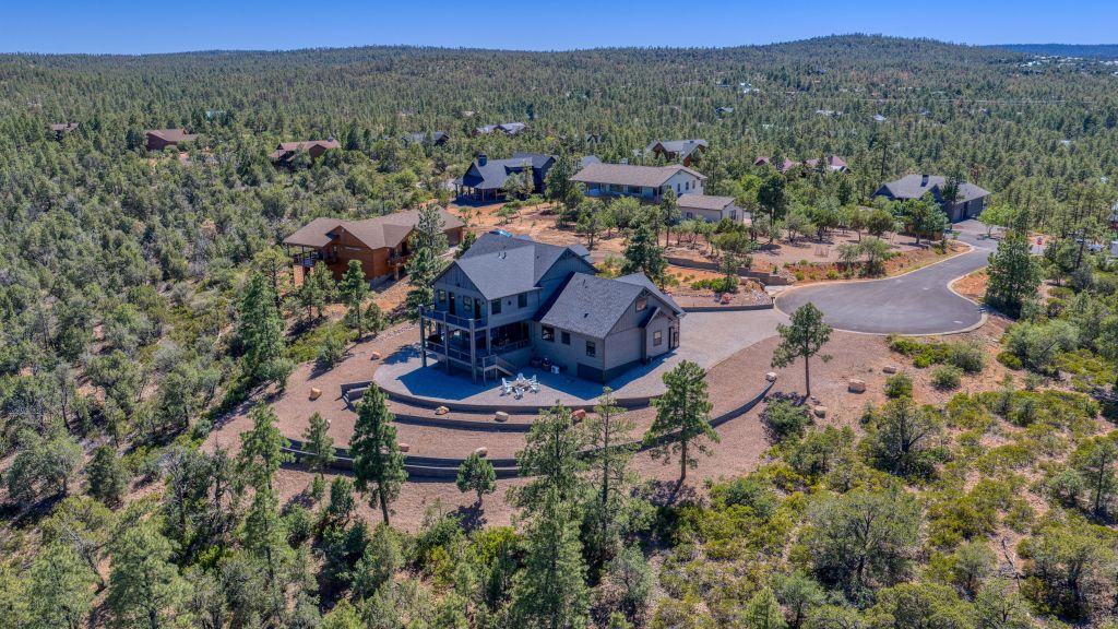 Aerial view of The Lazy Bear Way luxury vacation rental in Show Low, AZ surrounded by pine trees